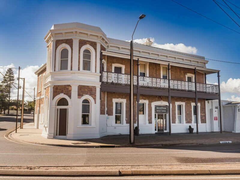 Front view of the Pastoral Hotel Motel’s heritage-style main building with intricate ironwork detail