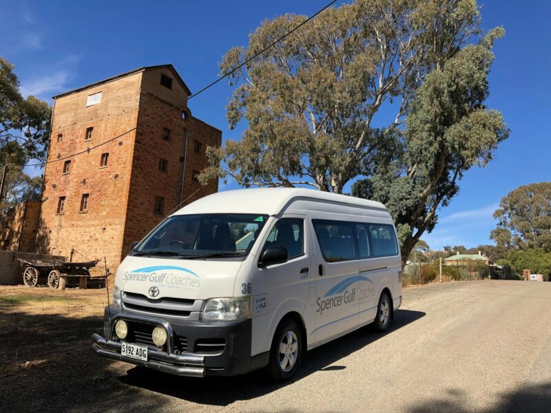 Micro Bus in front of Mill building