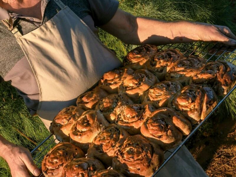 A tray of baked goods being held by the baker at Farina bakery